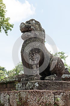 Stone lion on plinth guards East Mebon