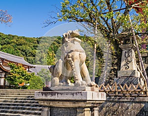 Stone lion sculpture near entrance to the ancient Kiyomizu-dera Buddhist temple in Kyoto, Japan