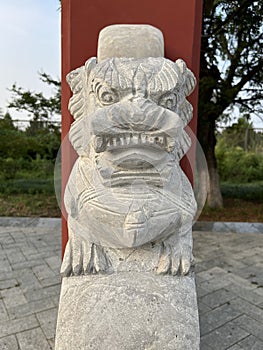 Stone lions on a bridge in a garden