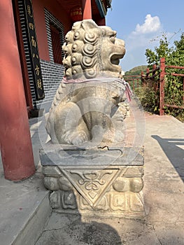 Stone lions on a bridge in a garden