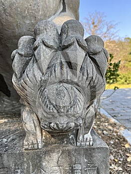 Stone lions on a bridge in a garden