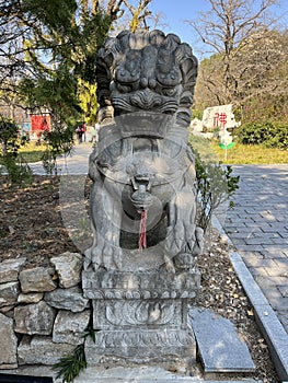 Stone lions on a bridge in a garden