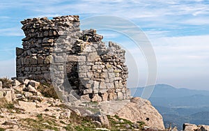 Stone-made building ancient ruins on the top of a cliff in the countyside