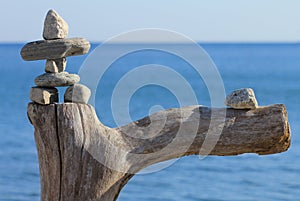 Stone man on dead tree