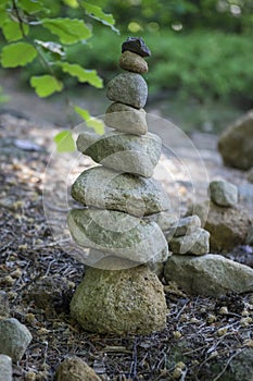 Stone man landart, sandstone stones high tower, harmony and balance, stone man on the path photo