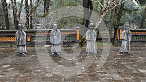 Stone mandarin sculptures in the forecort preceding the Stele Pavilion in Tu Duc Royal Tomb, Hue, Vietnam