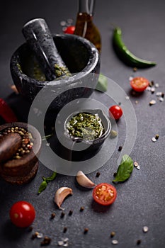 stone marble mortar with green capers, fennel and basil sauce