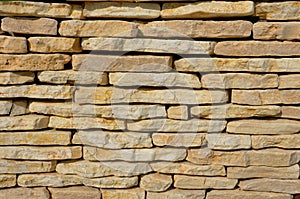 Stone marl walls with stone cladding by the pool, ponds, fire tanks. metal bike racks and trash cans included in the wall. rusty c