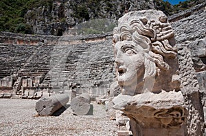 Stone mask and ancient amphitheater, Myra (Turkey)