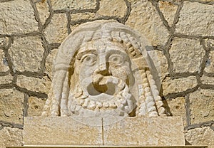 Stone mask on the old building.