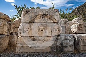 Stone masks at the ancient theatre of Myra in Demre, Antalya province of Turkey