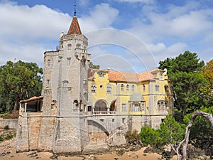 Stone masonry Saint Sebastian\'s Tower or colorful Palacio dos Condes de Castro Guimaraes, Cascais, Portugal. photo