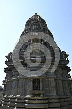 Stone masonry Shikhara with carvings of statue of Vishnu the God at Vitthal Temple, Palashi, Parner, Ahmednagar photo