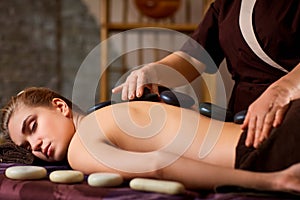 Stone massage back spa for a woman.