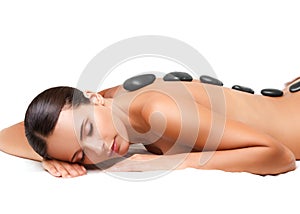 Stone Massage. Beautiful Woman Getting Spa Hot Stones Massage. S