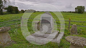 A stone memorial with information, in a field