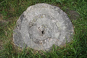 Stone millstone. Tools of the past. Granite. Household items of the past centuries. Story.