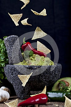 Stone Molcajete with Guacamole and Falling Chips