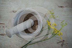 Stone mortar with anise seeds and flower