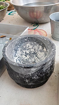 Stone mortar for grinding salt on the kitchen table