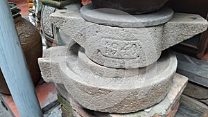 A stone mortar is old by the time is used to grind rice flour in 1940