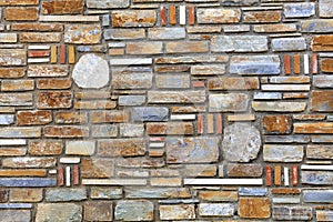 Stone multifaceted mosaic made of sandstone texture close-up