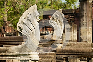 Stone nagas guarding the ruins of the Hindu temple in the Phimai Historical Park in Nakhon Ratchasima, Thailand.