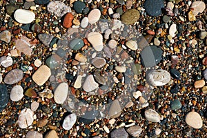 Stone natural background. Wet pebble stones in water