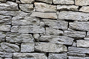 Stone natural rock texture background. Modern grunge wall castle made old granite of blocks. Wall rough old piece rock of mountain