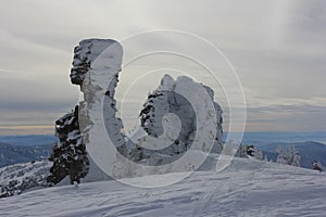 Stone northern idols covered with snow