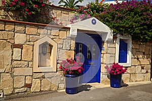 Stone old building house with blue wooden vintage door and windows. Bodrum, Turkey