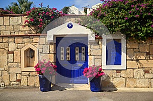 Stone old building house with blue wooden vintage door and windows. Bodrum, Turkey