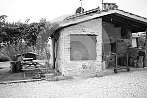 A stone oven with iron utensils for grilling meat with roof tiles and bricks in a farmhouse Umbria, Italy