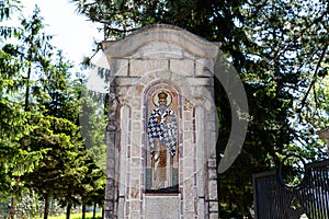 Stone in a park with religious mosaic art