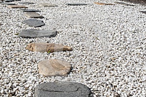 A stone path on a gravel backing in a Japanese garden