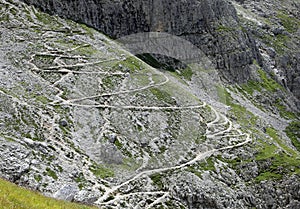 Stone path high in the Alps on zigzag slopes