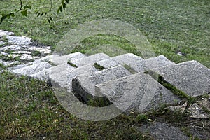 A stone path in the park and a granite staircase with steps. Stone steps in the garden