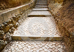 Stone path with steps leading to ocean.