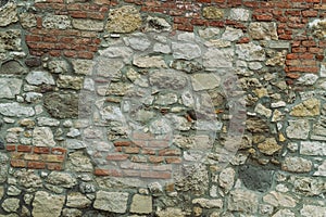 Stone pattern of gray cobblestones bricks wall of an old house