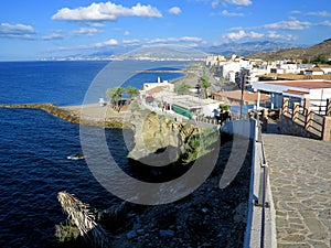 Stone paved cliff walking path with beautiful Mediterranean view and Torrenueva Costa town