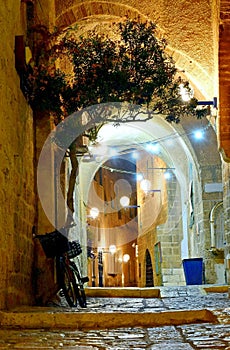 Stone-paved narrow quiet street in evening old Jaffa, Israel