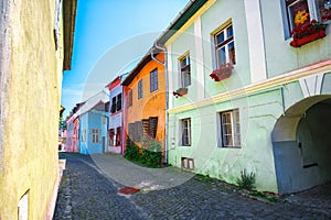 Stone paved old streets with colorful houses in the medieval city Sighishoara