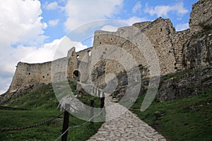 Stone paved path leading to an ancient fortress on a hill