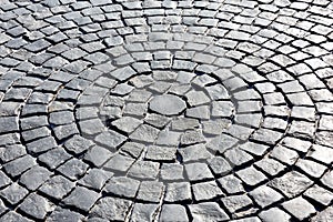 Stone pavement in perspective, texture of cobblestone road, gray cobbled road background