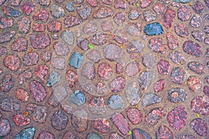 Stone pavement with rough wet granite boulders. Historic medieval cobble paving