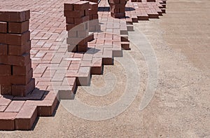 Stone Pavers bricks being layed on ground for landscaping project.