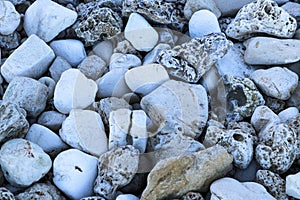 Stone pebble beach near river. natural background of cobblestones, pebbles and stones of different shapes, colors and textures