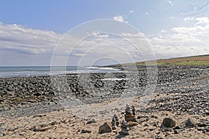 Stone pebble cairns on a beach