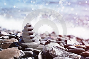 Stone pebble tower balancing on the beach. Copy space.