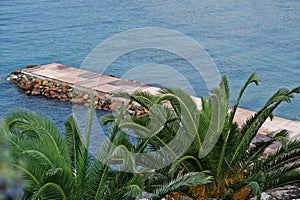 Stone pier. Scenic landscape with mountain islands and blue lagoon on Aegean sea. Exotic scenery. Popular landmark, famous